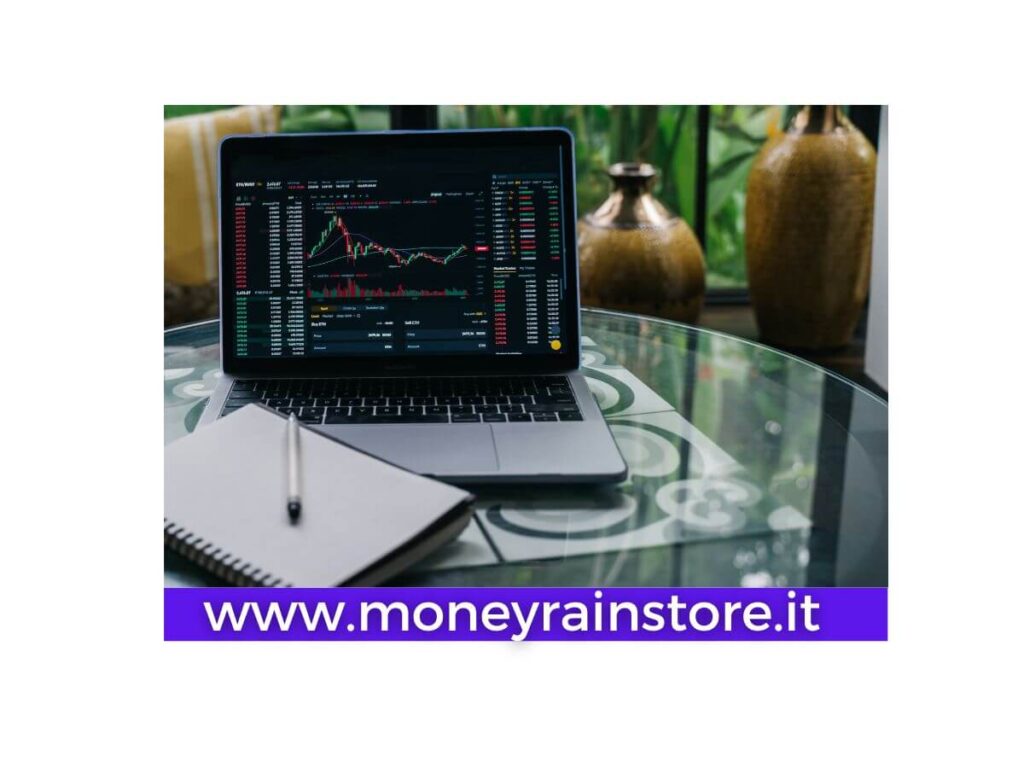 Exchange Cryptovalute. L'immagine mostra un pc portatile con un grafico delle varie crypto , un quaderno ed una penna per appunti