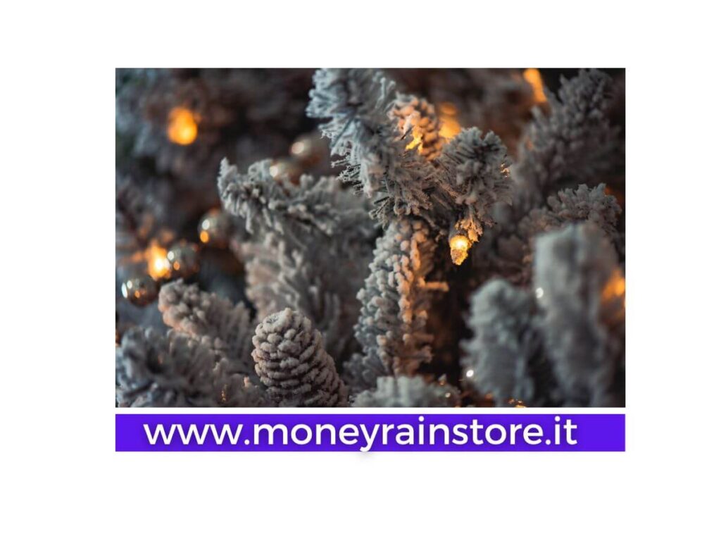 Albero di natale 2023 quale scegliere; la foto mostra un albero di natale totalmente innevato ( neve finta ) e delle luci